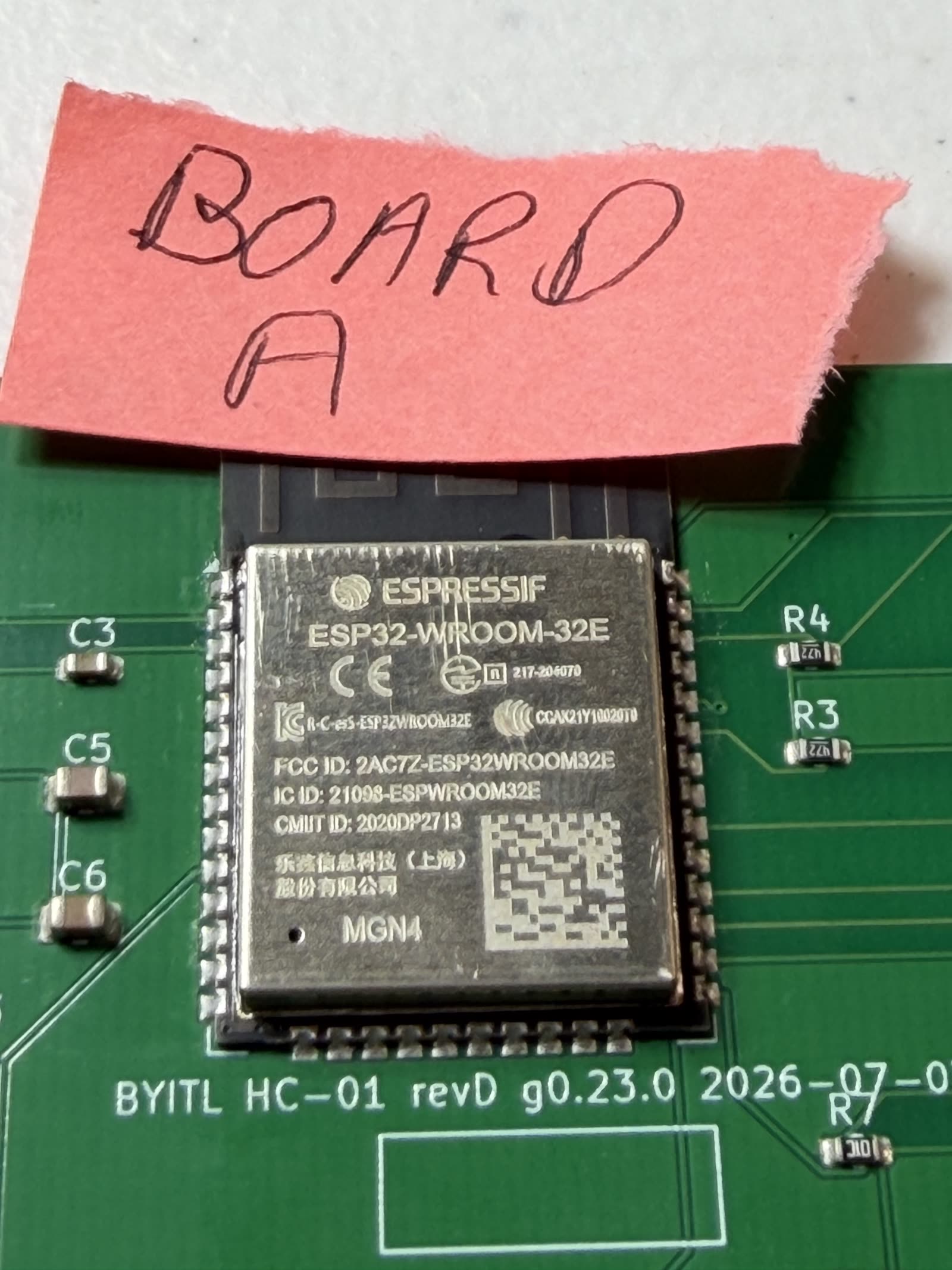 Close-up of the ESP32-WROOM-32E module on Board A, its castellated pads showing bright, well-formed solder fillets along both edges