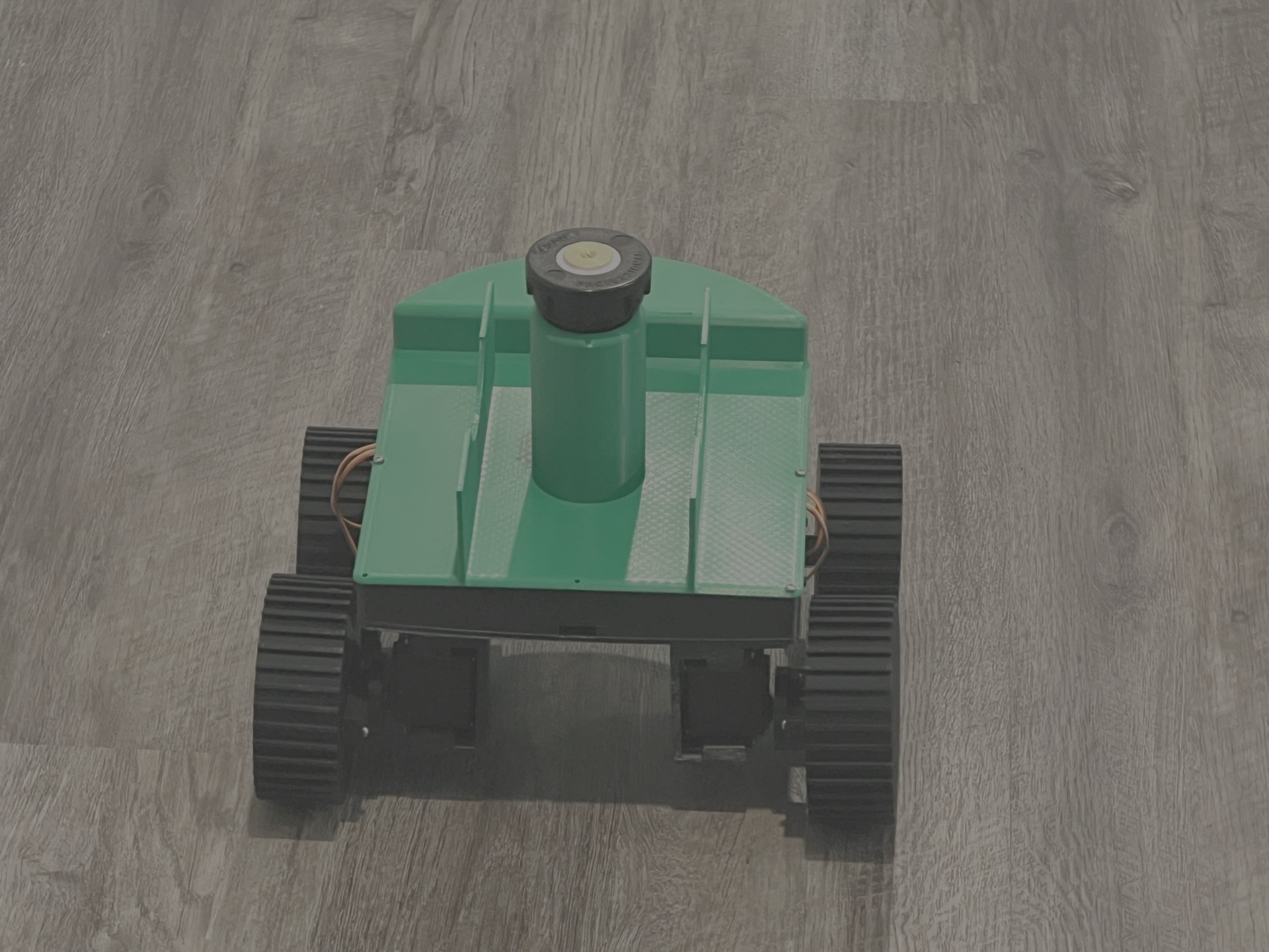 Second-round prototype: fully 3D-printed chassis with treaded wheels and the sprinkler head integrated.