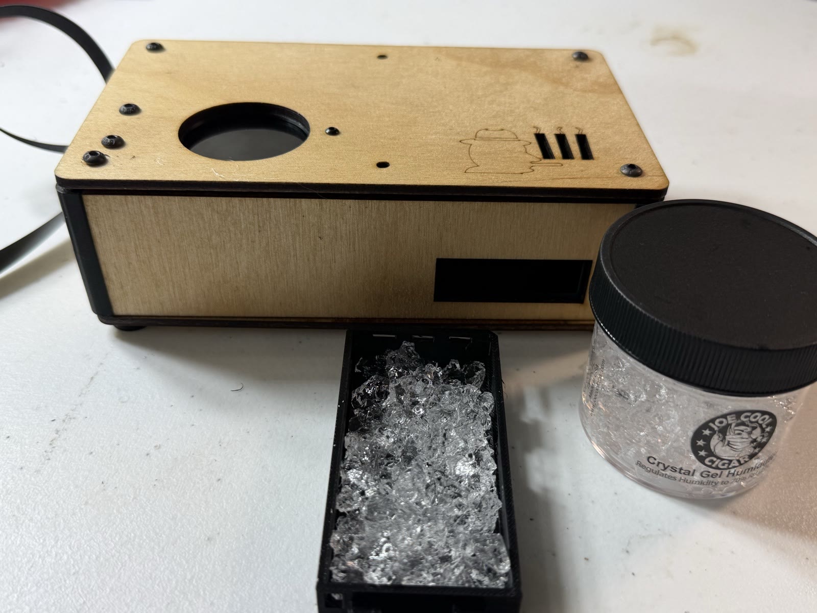 The bead drawer and a jar of humidity gel beside the assembled case.