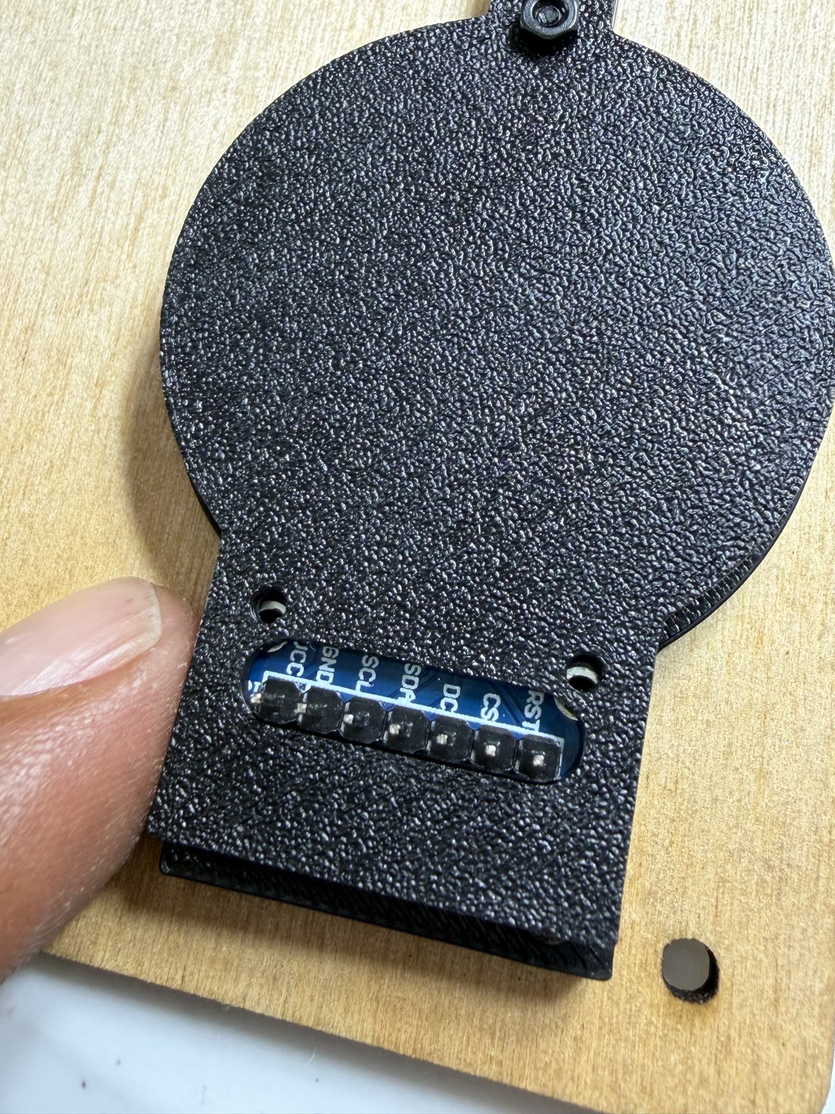 The printed display carrier from behind, with the header through its slot.