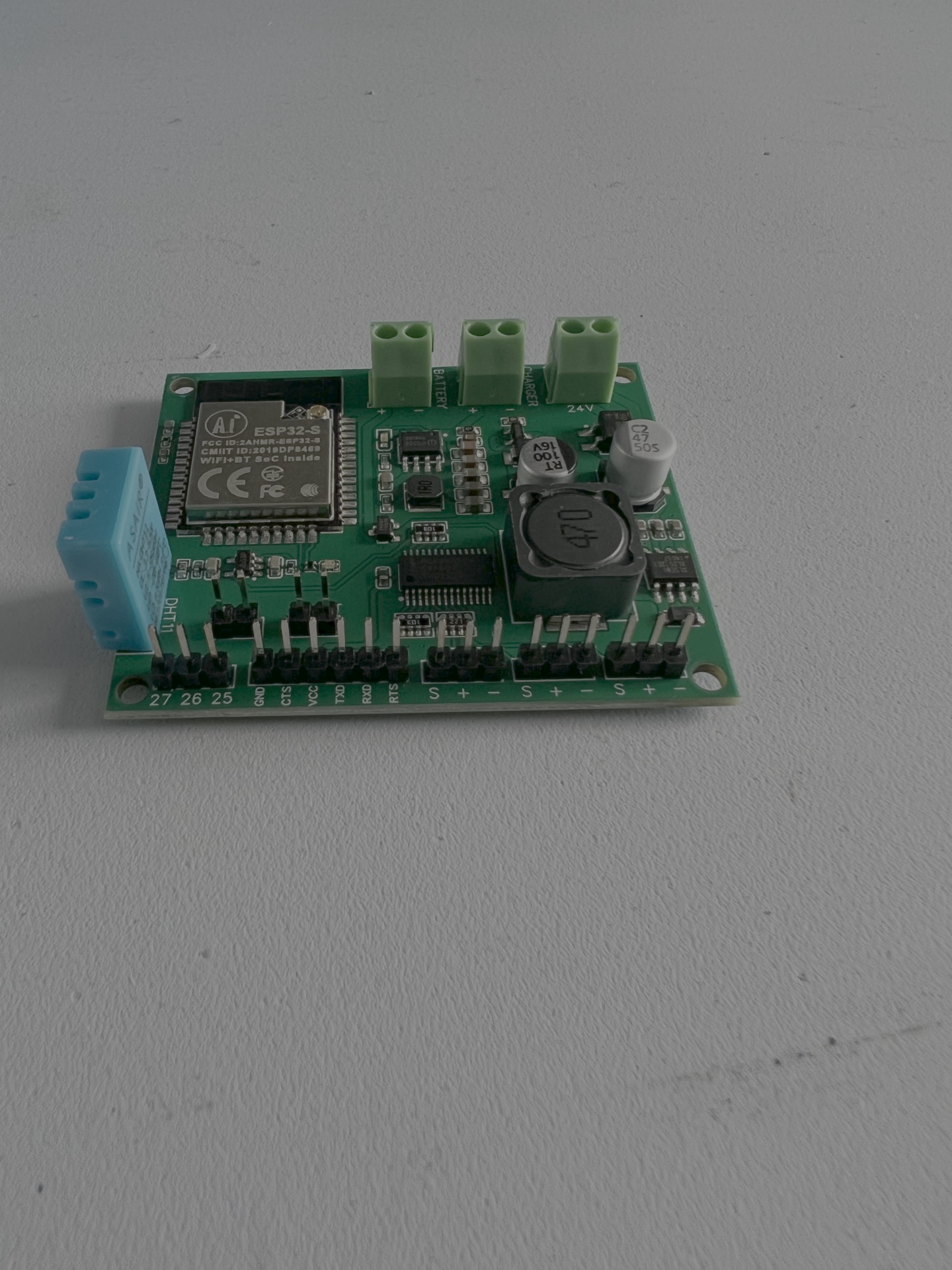 The custom PCB — ESP32-S wireless module, DHT11 humidity sensor, and battery + charger inputs.