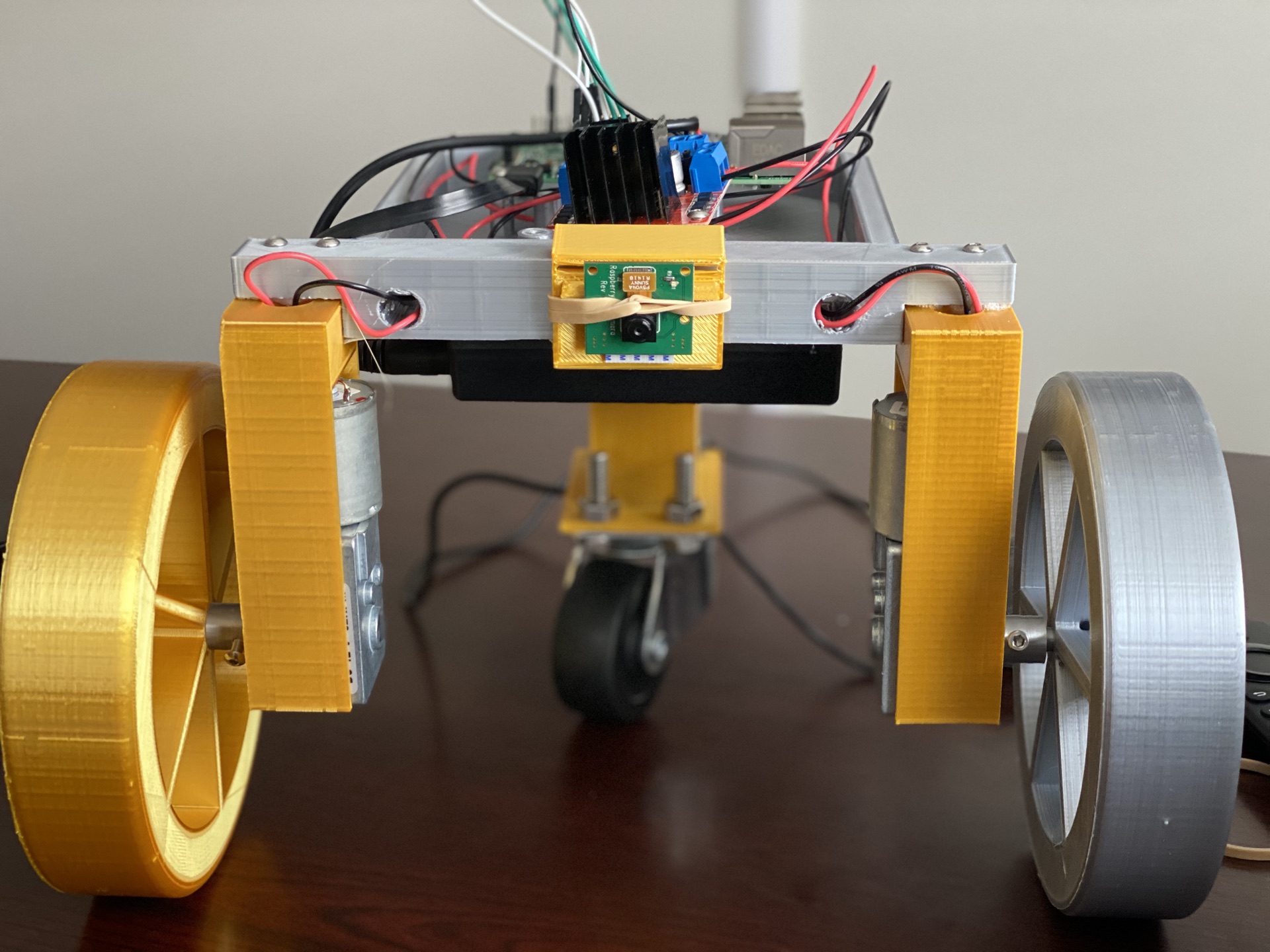 Same first iteration, further out — camera stack, motor mounts, and the caster wheel visible.