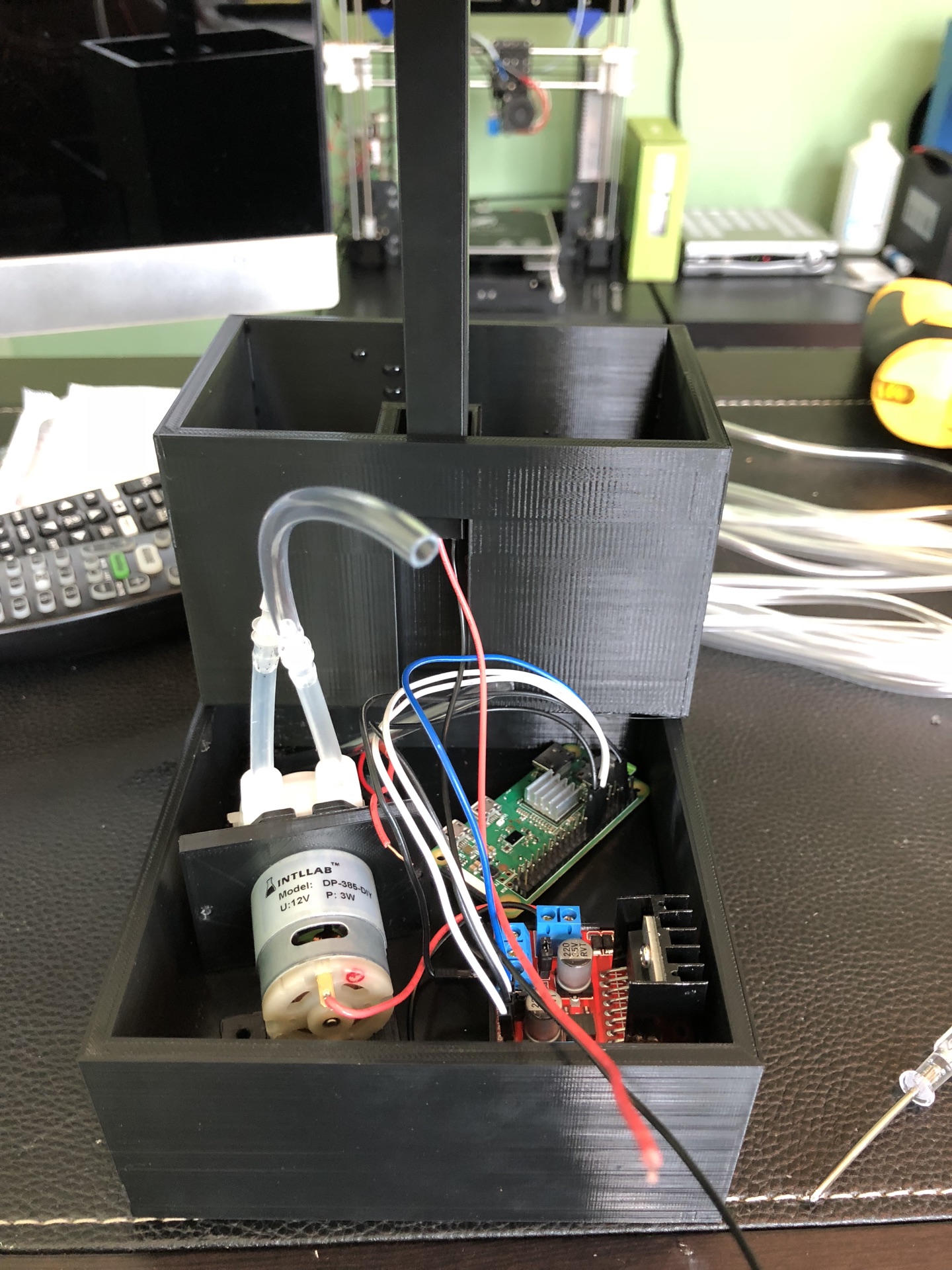 Inside the chassis: 12 V pump, Raspberry Pi Zero, and motor driver — all sitting on the 3D-printed shelf under the soil bed.